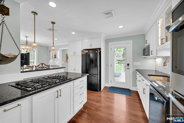 39 N 5th St, Park Ridge, NJ 07656 - kitchen with black appliances, ornamental molding, white cabinets, dark wood-style flooring, and decorative light fixtures