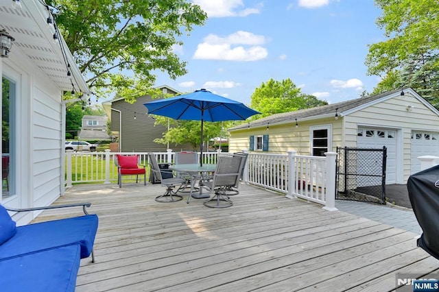 39 N 5th St, Park Ridge, NJ 07656 - wooden deck featuring outdoor dining area, a detached garage, and an outdoor structure