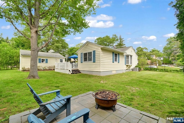 39 N 5th St, Park Ridge, NJ 07656 - back of property featuring a patio, a deck, a fire pit, and a yard