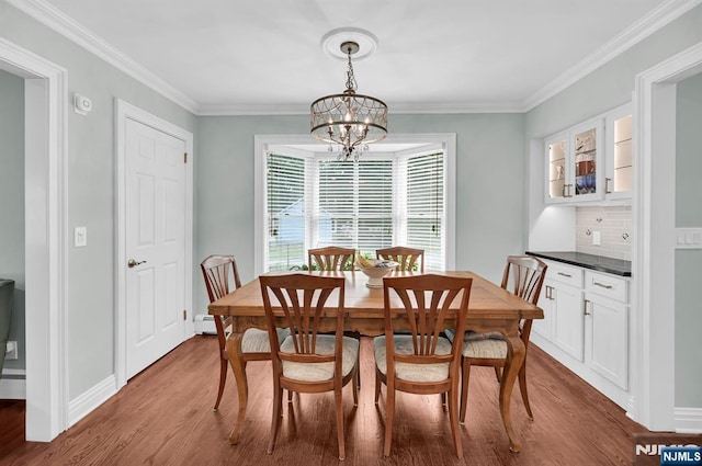 39 N 5th St, Park Ridge, NJ 07656 - dining room with a chandelier, baseboard heating, wood finished floors, and crown molding