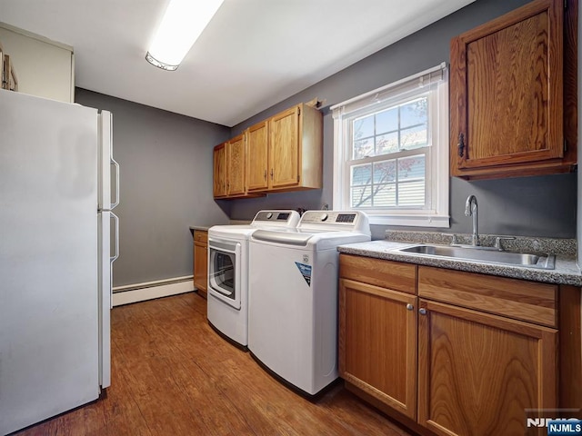 39 Daniels Dr, Clifton, NJ 07013 - washroom featuring baseboard heating, washing machine and dryer, dark wood-type flooring, and cabinet space