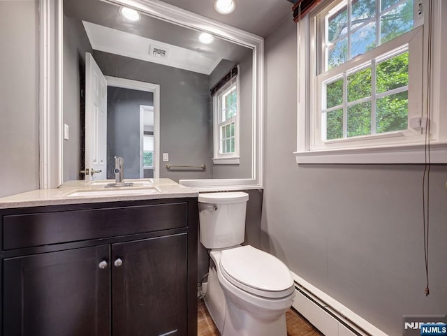 39 Daniels Dr, Clifton, NJ 07013 - bathroom with healthy amount of natural light, toilet, vanity, and a baseboard radiator