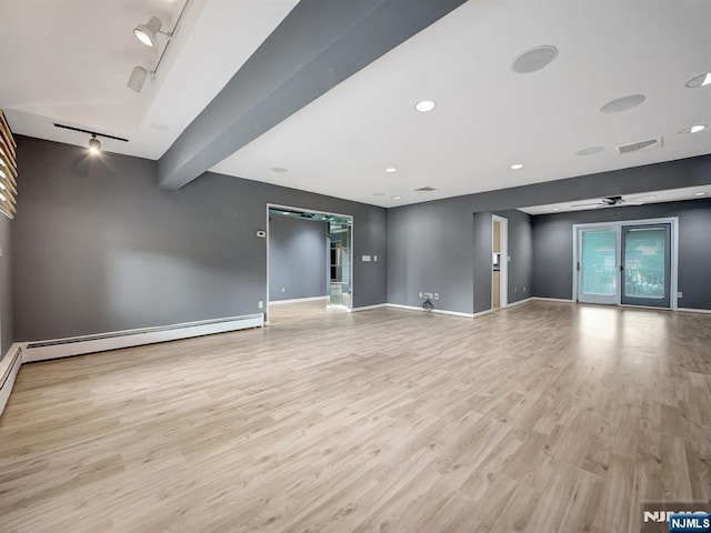 39 Daniels Dr, Clifton, NJ 07013 - unfurnished living room featuring rail lighting, wood finished floors, a baseboard heating unit, and baseboards