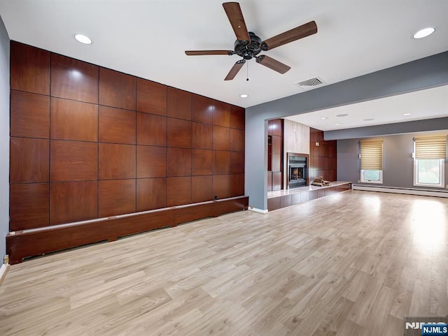 39 Daniels Dr, Clifton, NJ 07013 - unfurnished living room featuring a ceiling fan, light wood-style flooring, a baseboard radiator, a tile fireplace, and recessed lighting