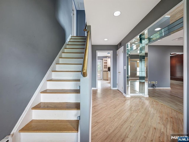 39 Daniels Dr, Clifton, NJ 07013 - stairs featuring wood finished floors, a baseboard radiator, baseboards, and recessed lighting
