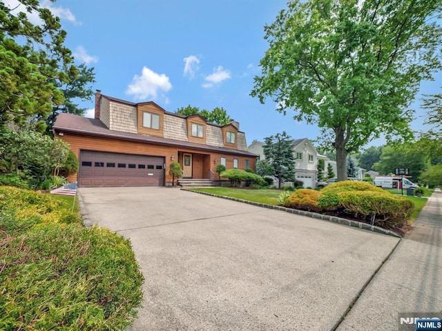 39 Daniels Dr, Clifton, NJ 07013 - view of front of property with a garage, concrete driveway, and a chimney