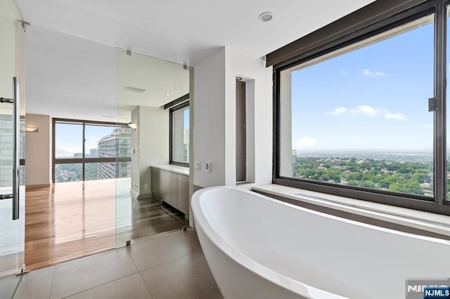 200 Old Palisade Unit Ph4/5, Fort Lee, NJ 07024 - bathroom with tile patterned flooring, a freestanding tub, plenty of natural light, and vanity