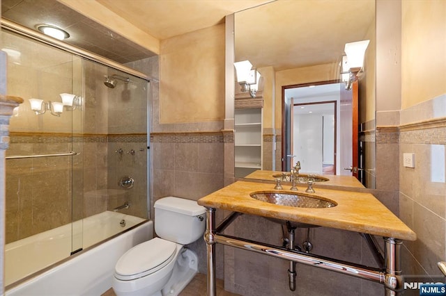 200 Old Palisade Unit Ph4/5, Fort Lee, NJ 07024 - full bathroom with tile walls, shower / bath combination with glass door, vanity, and wainscoting