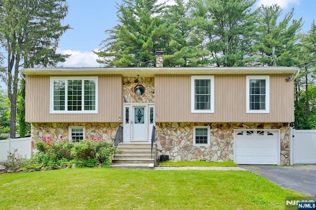 2 Fountain Dr, Ringwood, NJ 07456 - raised ranch featuring stone siding, asphalt driveway, a chimney, a garage, and entry steps