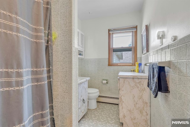 15 Jersey St, East Rutherford, NJ 07073 - full bathroom featuring baseboard heating, tile walls, vanity, a shower with shower curtain, and tile patterned flooring