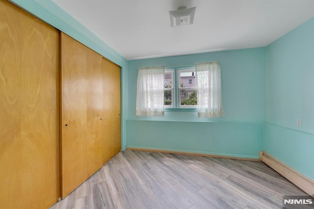 15 Jersey St, East Rutherford, NJ 07073 - unfurnished bedroom with a closet, wood finished floors, and baseboard heating