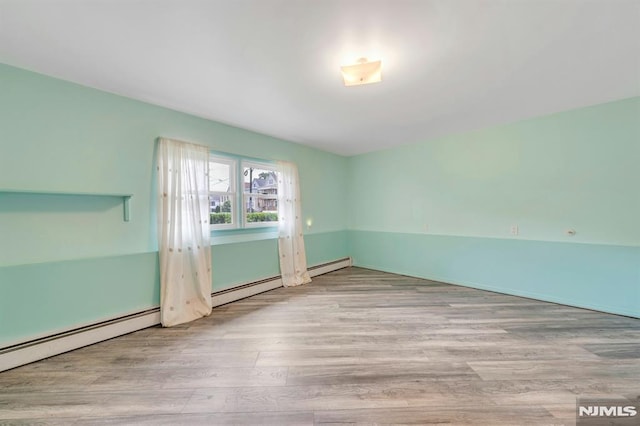15 Jersey St, East Rutherford, NJ 07073 - empty room featuring wood finished floors and a baseboard radiator