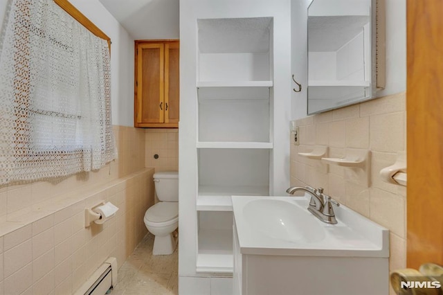 15 Jersey St, East Rutherford, NJ 07073 - bathroom with tile walls, tile patterned flooring, vanity, and a baseboard radiator