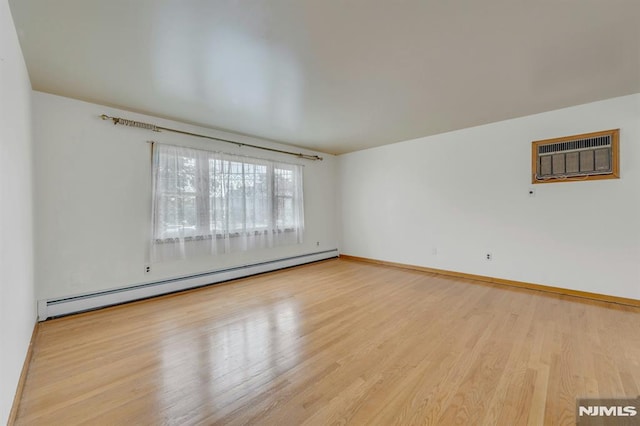 15 Jersey St, East Rutherford, NJ 07073 - unfurnished room with a baseboard radiator, wood finished floors, and an AC wall unit