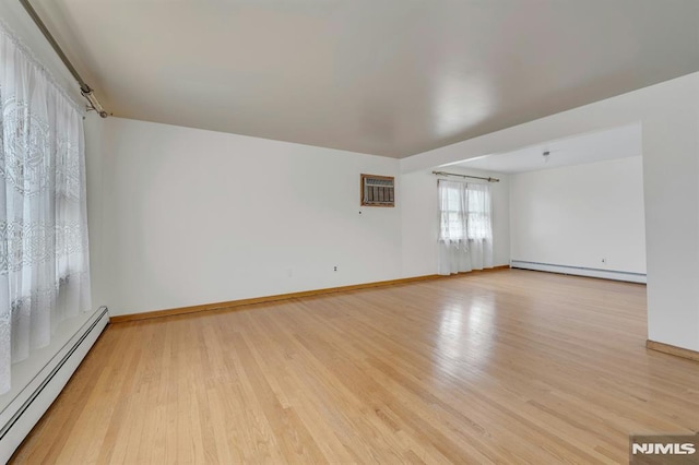 15 Jersey St, East Rutherford, NJ 07073 - empty room with a baseboard heating unit, baseboard heating, light wood-type flooring, and a wall mounted AC