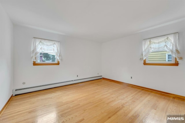 15 Jersey St, East Rutherford, NJ 07073 - spare room with baseboard heating and wood finished floors