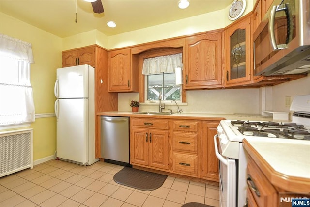 62 Overlook Ave, North Haledon, NJ 07508 - kitchen with appliances with stainless steel finishes, radiator, light countertops, light tile patterned flooring, and ceiling fan