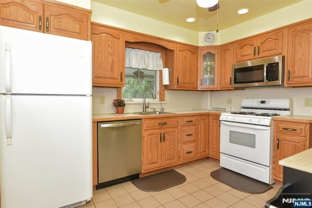 62 Overlook Ave, North Haledon, NJ 07508 - kitchen featuring appliances with stainless steel finishes, light countertops, ceiling fan, glass insert cabinets, and light tile patterned floors