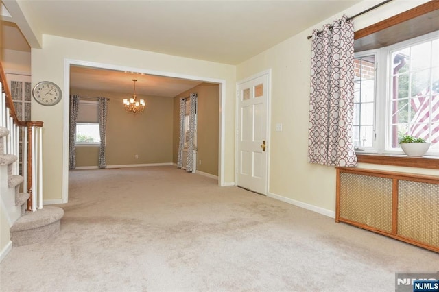 62 Overlook Ave, North Haledon, NJ 07508 - carpeted spare room with a chandelier, radiator heating unit, and stairs