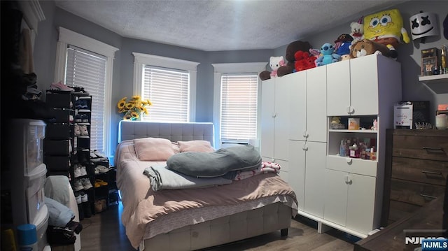 20 2nd Ave, Paterson, NJ 07524 - bedroom with wood finished floors and a textured ceiling