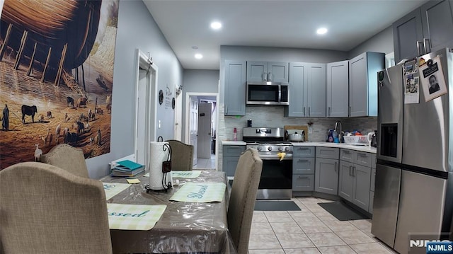 20 2nd Ave, Paterson, NJ 07524 - kitchen with stainless steel appliances, gray cabinetry, backsplash, light countertops, and recessed lighting