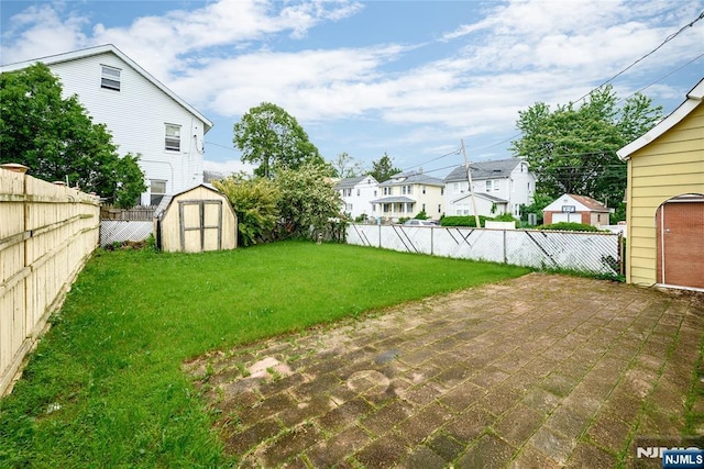139 Marietta Ave, Passaic, NJ 07055 - fenced backyard with a residential view, a storage shed, and a patio