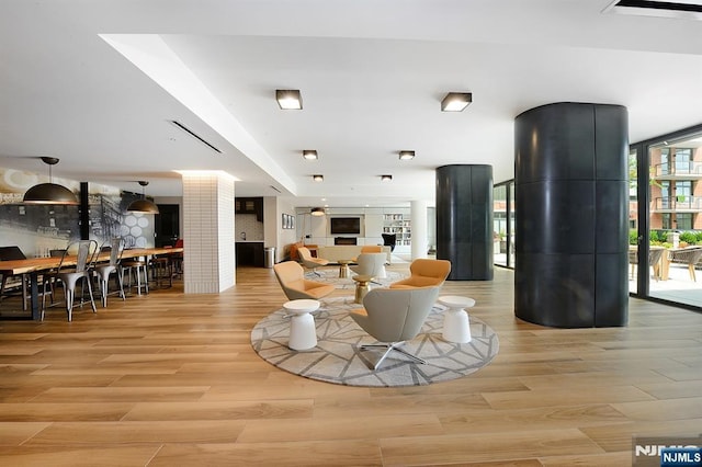 1400 Hudson St Unit 730, Hoboken, NJ 07030 - living room with light wood-style flooring and decorative columns