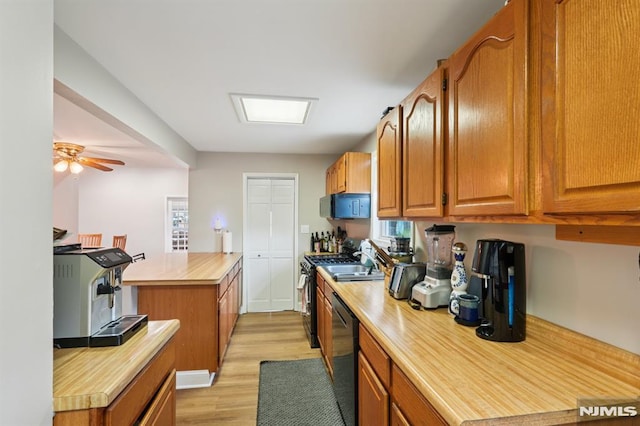 4 Lenape Trl, Wayne, NJ 07470 - kitchen with dishwashing machine, light wood-style floors, stainless steel gas stove, and brown cabinets
