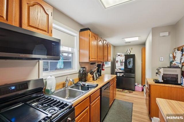 4 Lenape Trl, Wayne, NJ 07470 - kitchen featuring stainless steel appliances, a sink, light wood finished floors, light countertops, and brown cabinets