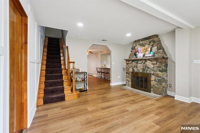 4 Lenape Trl, Wayne, NJ 07470 - living room with arched walkways, stairs, wood finished floors, baseboards, and recessed lighting