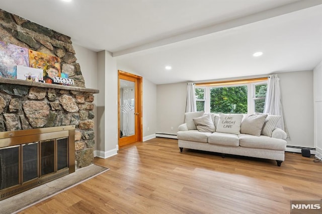 4 Lenape Trl, Wayne, NJ 07470 - living area with baseboard heating, wood finished floors, baseboards, a stone fireplace, and recessed lighting