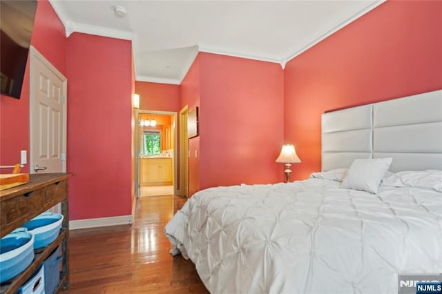 7400 River Rd Unit 120, North Bergen, NJ 07047 - bedroom featuring wood finished floors, ornamental molding, and ensuite bathroom