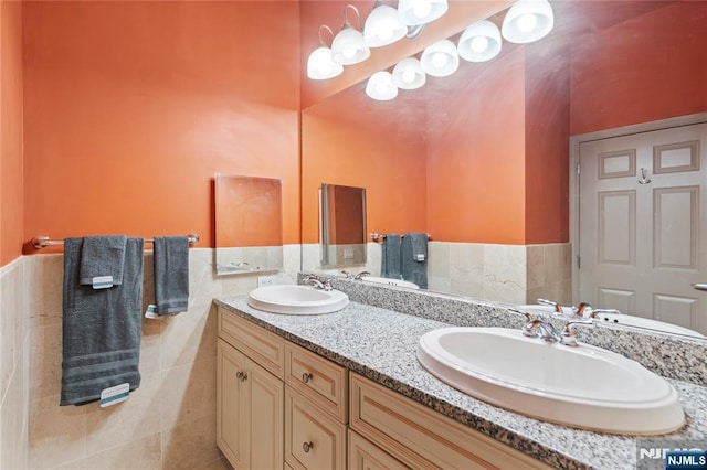 7400 River Rd Unit 120, North Bergen, NJ 07047 - full bath with double vanity, a wainscoted wall, and tile walls