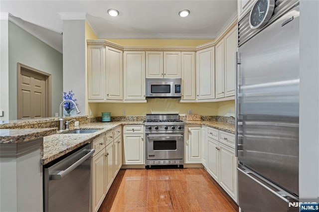 7400 River Rd Unit 120, North Bergen, NJ 07047 - kitchen with premium appliances, crown molding, light wood finished floors, cream cabinets, and recessed lighting