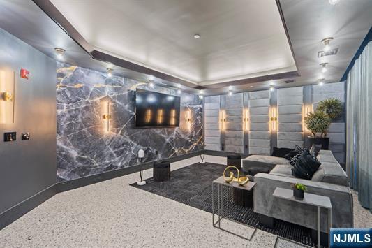 7400 River Rd Unit 120, North Bergen, NJ 07047 - home theater room with a raised ceiling and speckle patterned floor