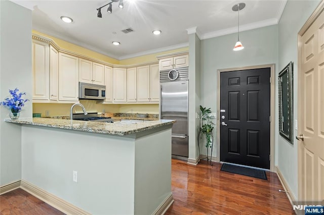 7400 River Rd Unit 120, North Bergen, NJ 07047 - kitchen with cream cabinets, appliances with stainless steel finishes, light stone counters, a peninsula, and crown molding
