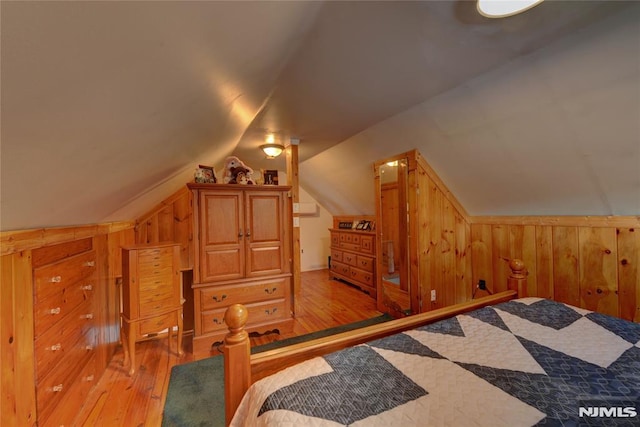 21 Bartholdi Ave, Wanaque, NJ 07420 - bedroom featuring wood walls, light wood-type flooring, and vaulted ceiling