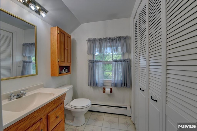 21 Bartholdi Ave, Wanaque, NJ 07420 - bathroom featuring a baseboard heating unit, a closet, vanity, tile patterned floors, and vaulted ceiling