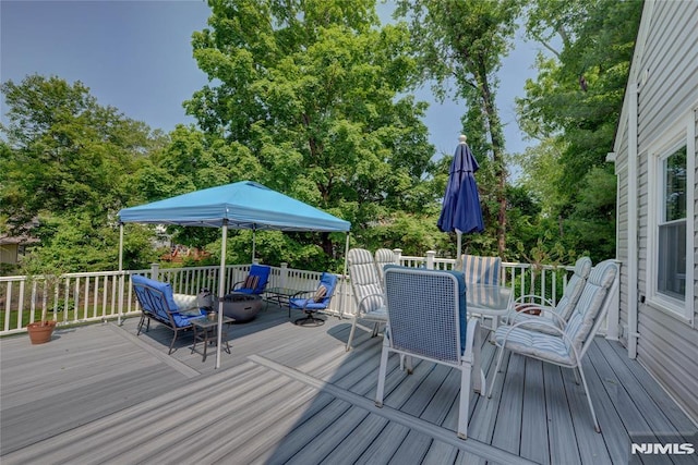 21 Bartholdi Ave, Wanaque, NJ 07420 - deck with outdoor dining space and view of wooded area