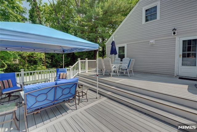 21 Bartholdi Ave, Wanaque, NJ 07420 - deck featuring an outdoor living space, outdoor dining area, and view of wooded area