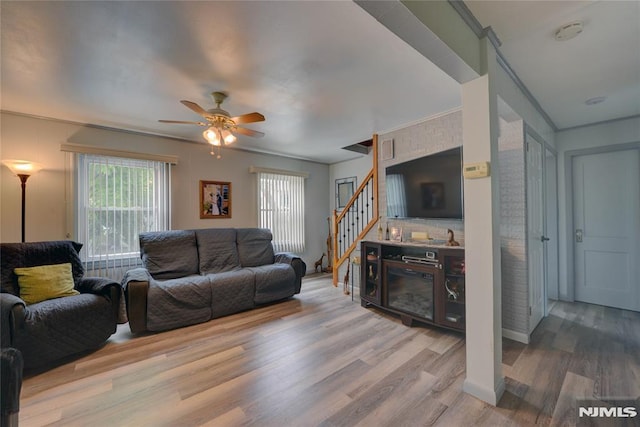 21 Bartholdi Ave, Wanaque, NJ 07420 - living room with healthy amount of natural light, wood finished floors, a ceiling fan, stairway, and ornamental molding