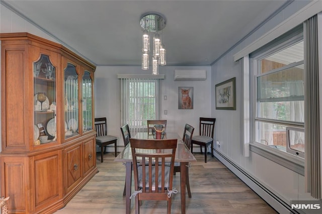 21 Bartholdi Ave, Wanaque, NJ 07420 - dining space with baseboard heating, an AC wall unit, a chandelier, light wood finished floors, and ornamental molding