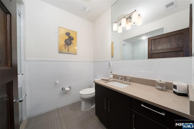 9 Somerset Ln Unit 201, Edgewater, NJ 07020 - full bath with tile walls, vanity, a wainscoted wall, a shower, and tile patterned flooring