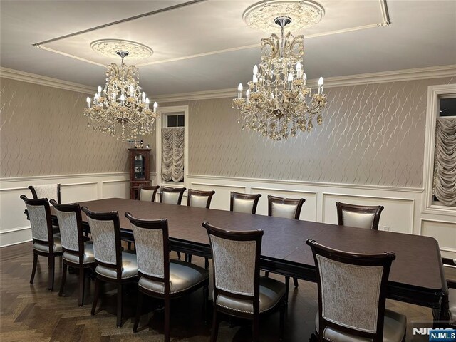 591 Warwick Ave, Teaneck, NJ 07666 - dining room featuring a chandelier, a decorative wall, a wainscoted wall, and ornamental molding