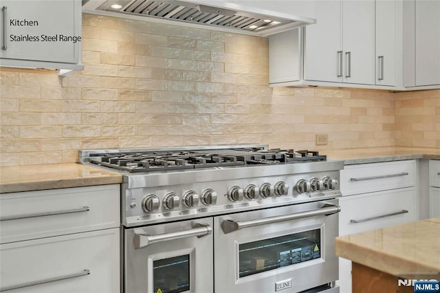 333 Mill Rd, Saddle River, NJ 07458 - kitchen with range with two ovens, custom range hood, tasteful backsplash, and white cabinets