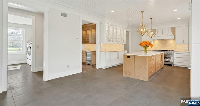 333 Mill Rd, Saddle River, NJ 07458 - kitchen featuring stainless steel stove, wine cooler, custom exhaust hood, recessed lighting, and backsplash