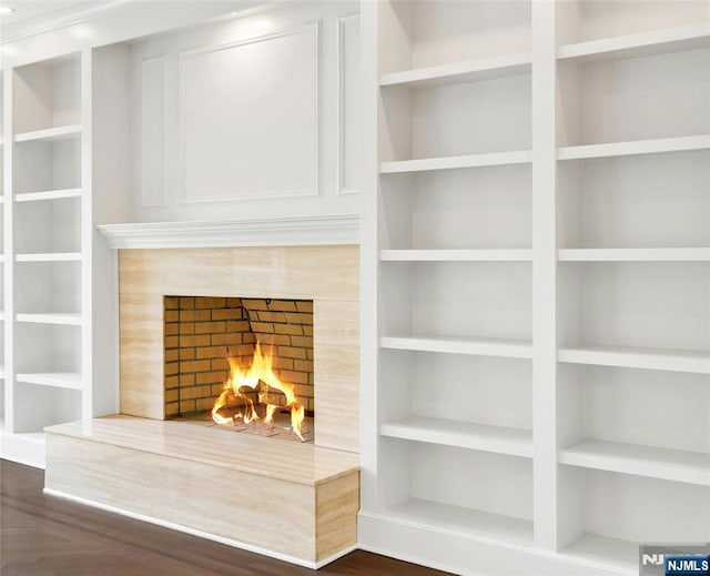 333 Mill Rd, Saddle River, NJ 07458 - detailed view of built in shelves and a tiled fireplace