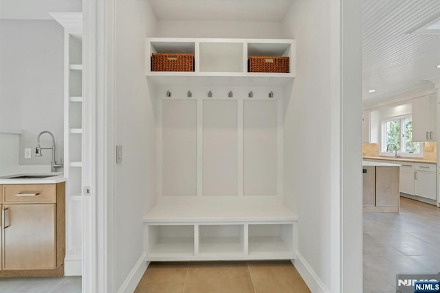 333 Mill Rd, Saddle River, NJ 07458 - mudroom featuring a sink and light tile patterned floors