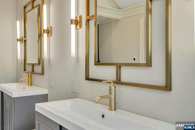333 Mill Rd, Saddle River, NJ 07458 - bathroom featuring two vanities and crown molding