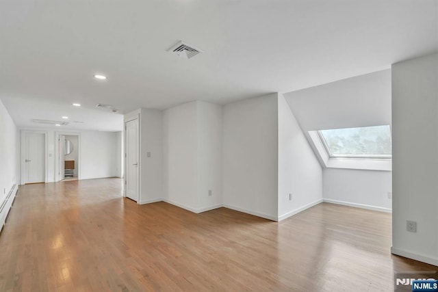 333 Mill Rd, Saddle River, NJ 07458 - unfurnished living room with a skylight, recessed lighting, and wood finished floors